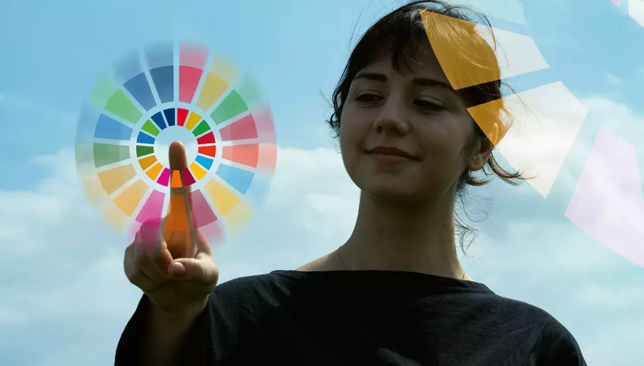 Girl pointing at SDG circle