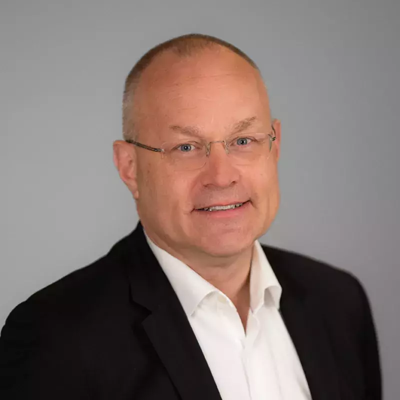 man in glasses with white shirt and black blazer