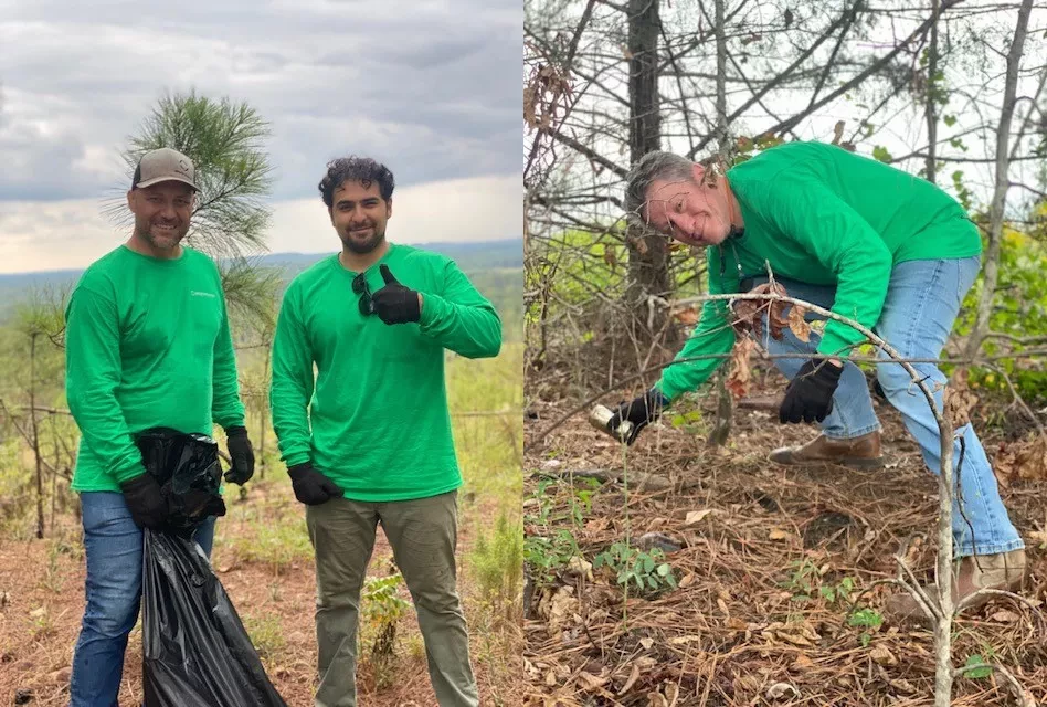 Three men with green shirts picking trash by river