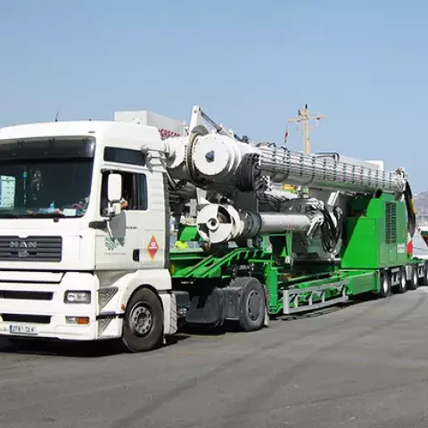 Road-mobile unloader folded away on a trailer, transported on road