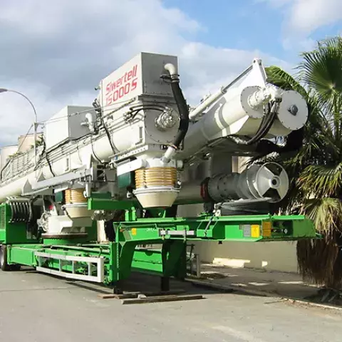 Road-mobile unloader folded away on a trailer