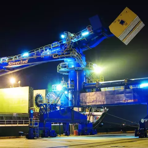 Blue Siwertell Ship unloader in operation at night