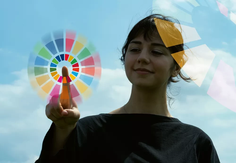 Girl pointing at SDG circle