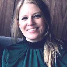 Headshot of woman with long hair and green shirt