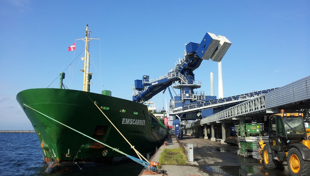 Siwertell shipunloader and conveyor on jetty unloading from ship with sea in background