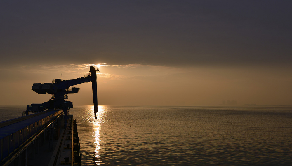 Ship unloader in sunset