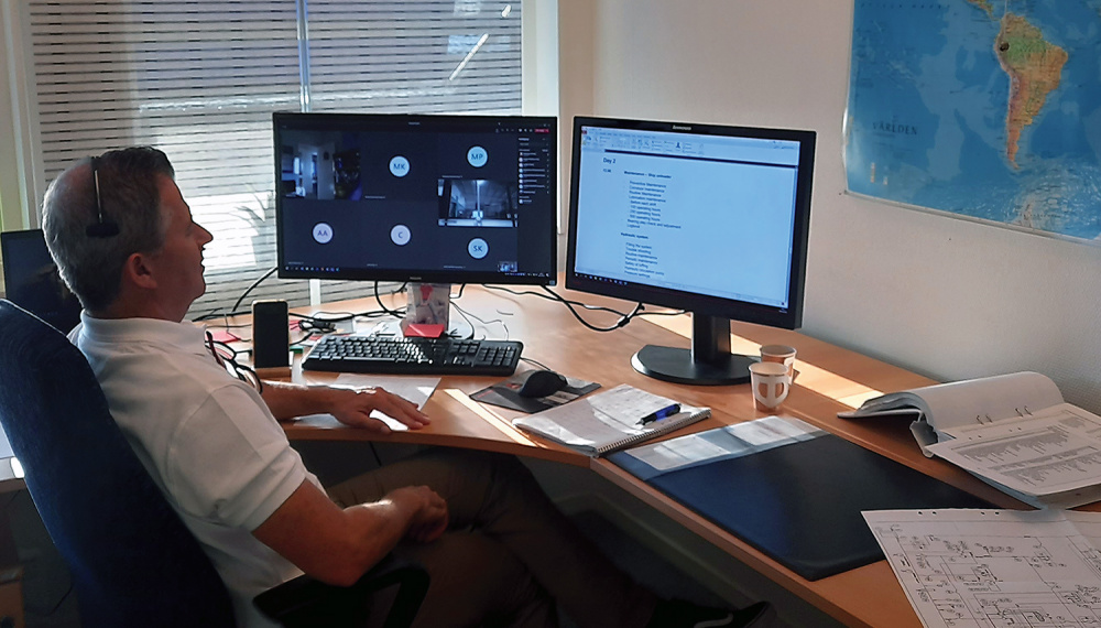 A person sitting in front of two screens supporting customers