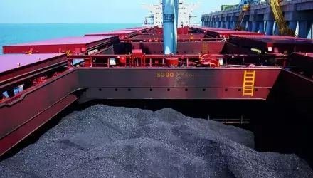 bulk coal in ship hold with screw conveyor unloading ongoing