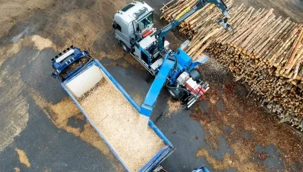 mobile chipper, wood logs and truck from drone view
