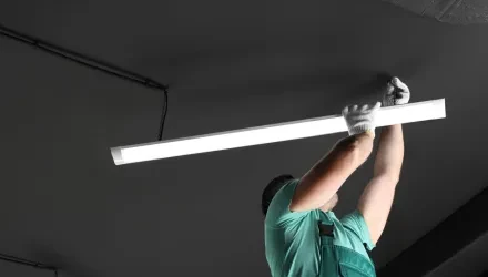 man installing lights in ceiling