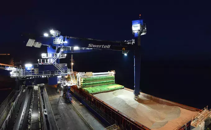 Blue Siwertell Ship unloader in operation at night