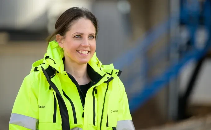 a woman in high visibility jacket
