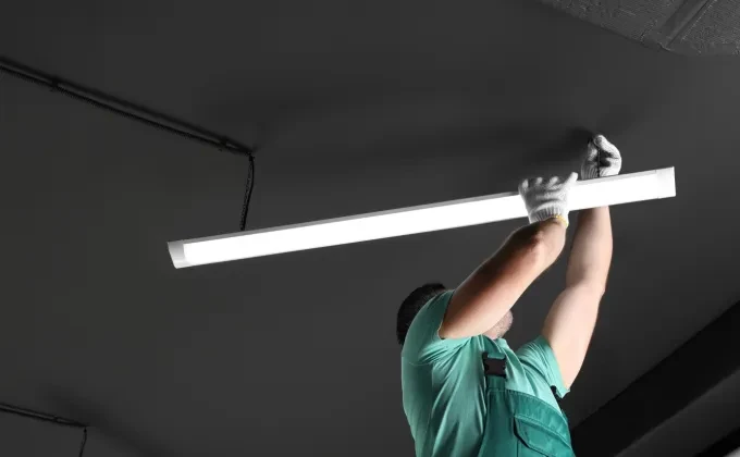 man installing lights in ceiling