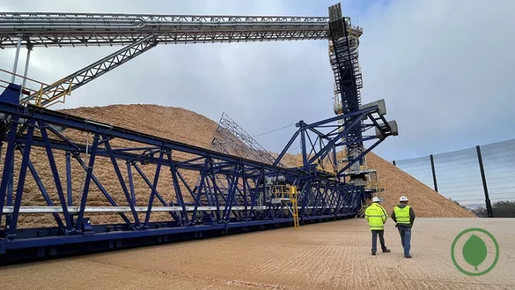big conveyor infront of sand hills and two men